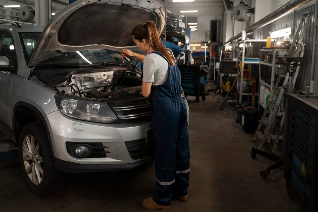 female mechanic working shop car