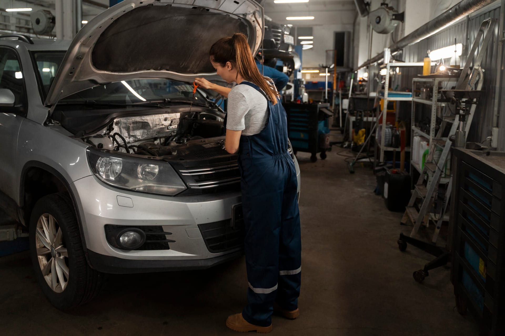 female mechanic working shop car
